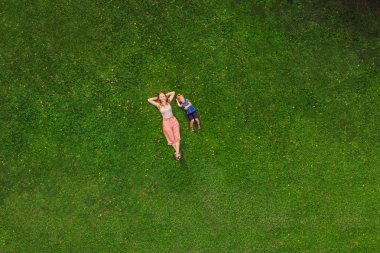 Anne ve oğlu parkta, çimlerin üzerine fotoğraflardan dron, quadracopter yalan söylüyorsun.