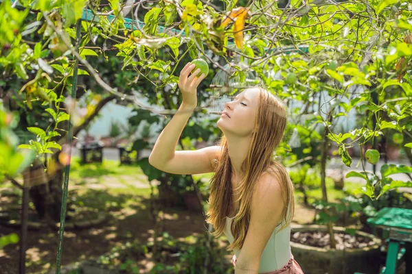 Genç kadın bahçede tutku meyve kokulu.