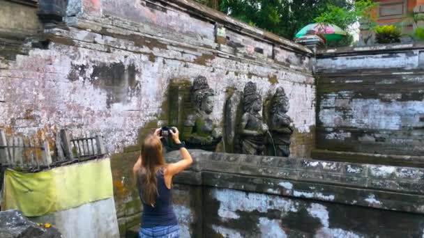 Młoda Kobieta Fotografowanie Starożytnych Posągów Podczas Gdy Chłopiec Chodzą Świątyni — Wideo stockowe