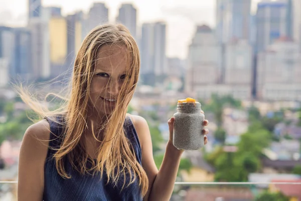 Young Woman Eating Chia Pudding Her Balcony Overlooking Big City — Stock Photo, Image