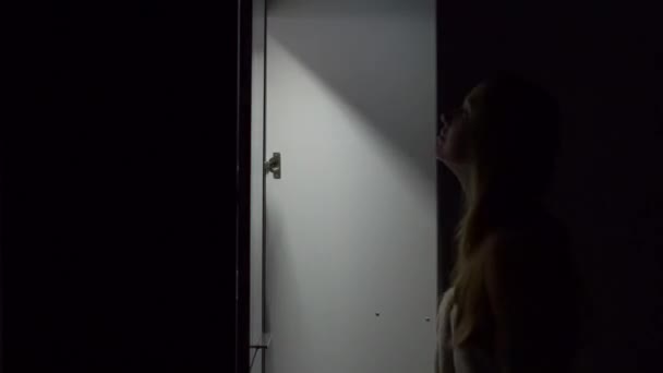 Mujer joven por la noche abre un armario y elegir el vestido para en — Vídeos de Stock