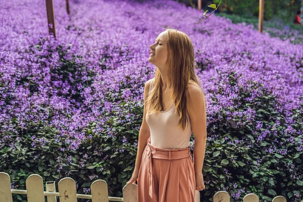 Young woman on lavenders field. Lavender farm concept.