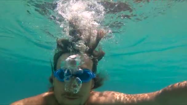 Tikje shot van een jongeman duiken en plezier ik een pool — Stockvideo