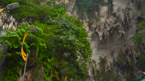 Ancient Batu caves in Malaysia having a hindu temple inside — Stock Video