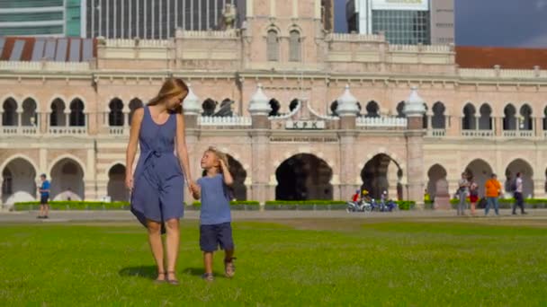 Young woman and her little son walking at the Merdeka Square, Kuala Lumpur, Malaysia — Stock Video