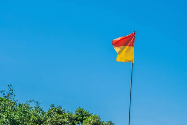 Red yellow flag, the territory where you can swim at the beach.