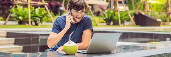 Young freelancer working on vacation next to the swimming pool. BANNER, long format