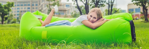 Mujer joven descansando en un sofá de aire en el parque. BANNER, formato largo — Foto de Stock