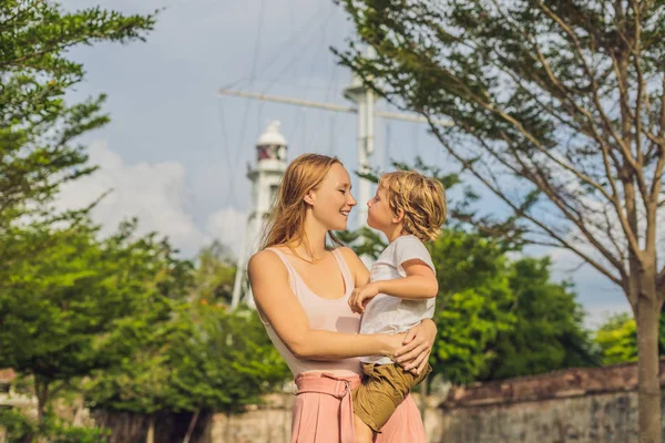 Mom and son on background of Fort Cornwallis in Georgetown, Penang, is a star fort built by the British East India Company in the late 18th century, it is the largest standing fort in Malaysia. Traveling with child concept.