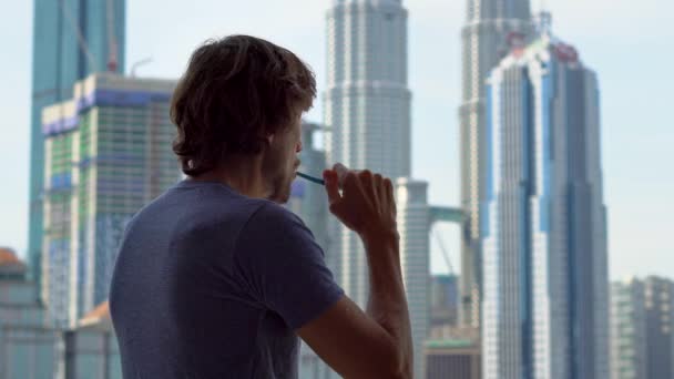 Young Man Brushing Teeth Standing Window City View — Stock Video