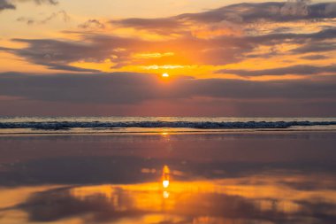 suda günbatımı sırasında yansıtan Bali Adası