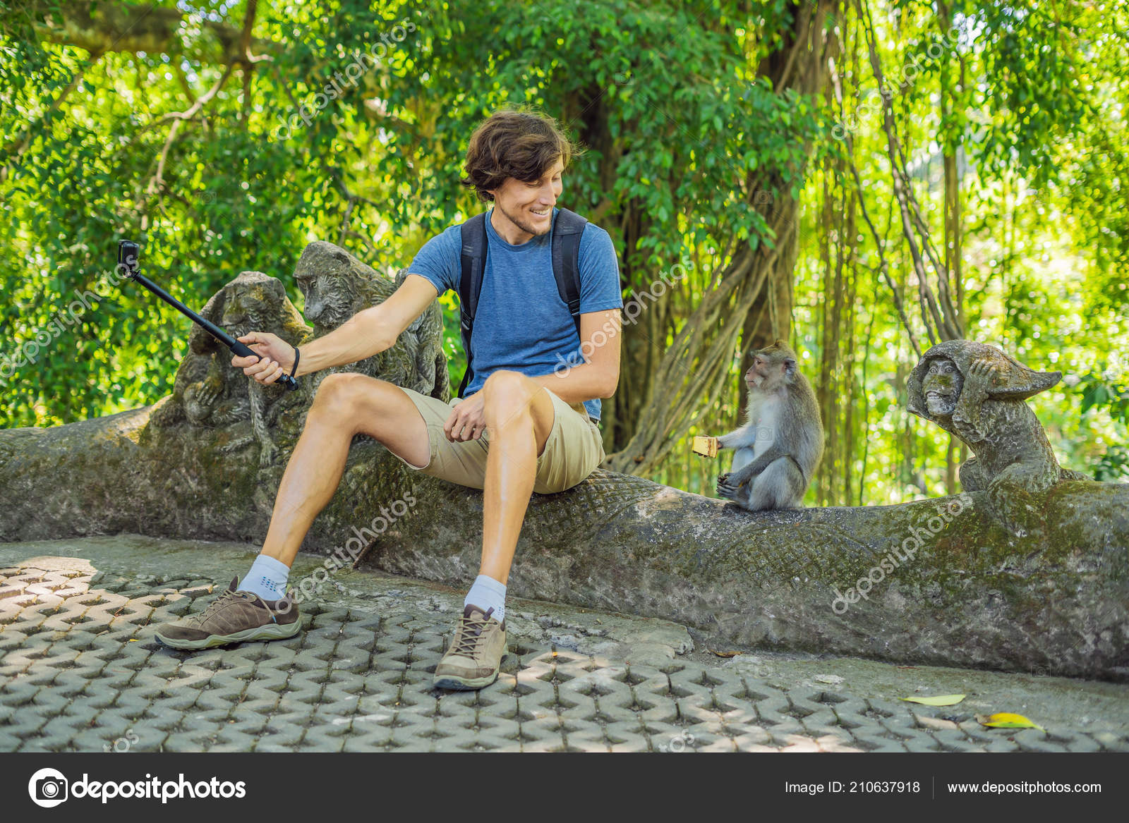 Young Man Using Selfie Stick Taking Selfie Funny Macaque Monkey Stock Photo by ©galitskaya