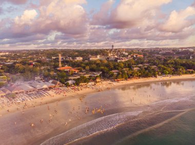Aerial view of Balinese Jimbaran beach with seafood restaurants and people clipart