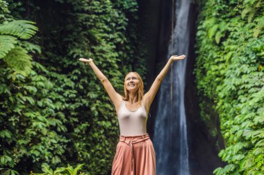 Genç kadın turist Leke Leke şelale Bali Adası, Endonezya arka plan üzerinde