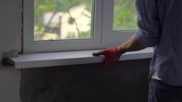 Young Man Gloves Installing Window Sill Indoors — Stock Video