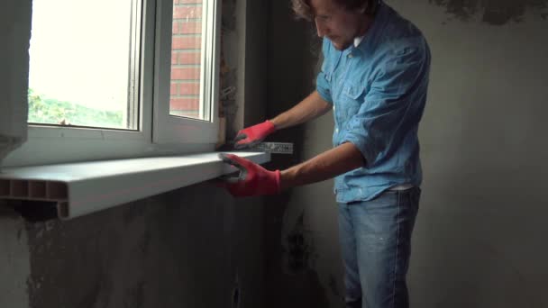 Young Man Gloves Installing Window Sill Indoors — Stock Video