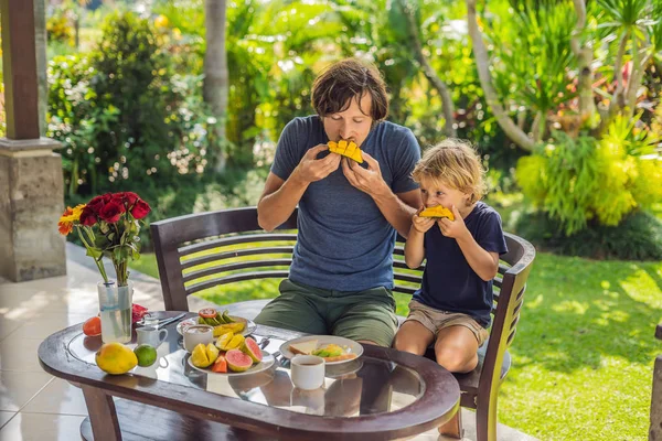 Padre Hijo Comiendo Mango Juntos Por Mañana Terraza —  Fotos de Stock