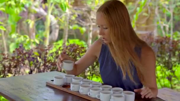 Jovem mulher em uma degustação de chá, degustationin um café tropical — Vídeo de Stock