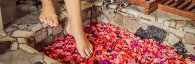 Kadın banyoda ayak yaprakları tropikal çiçek ve aroma yağları ile görünümünü kırpılmış.