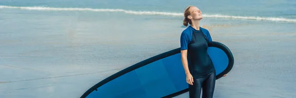 Young woman in swimsuit with surf for beginner ready to surf.