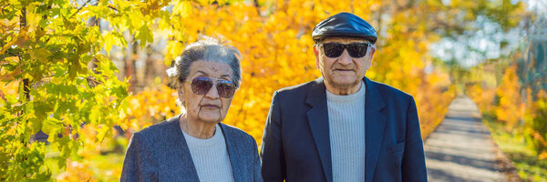 Pensioners in sunglasses in the autumn forest. Pensioners like gangsters BANNER, LONG FORMAT
