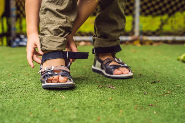 Little boy wearing orthopedic shoes in playground