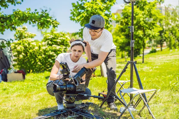 Two young filmmakers on a commercial production exterior set — Stock Photo, Image