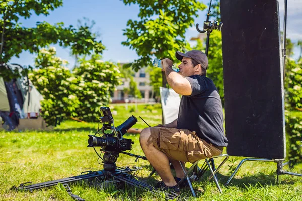 Processo de filmagem no palco do cinema - conjunto de produção comercial, localização externa.Cameraman profeccional opera a câmera — Fotografia de Stock