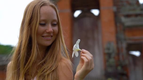 Tikje shot van een jonge vrouw lopen rond het Taman Ayun Tempel op het eiland Bali — Stockvideo