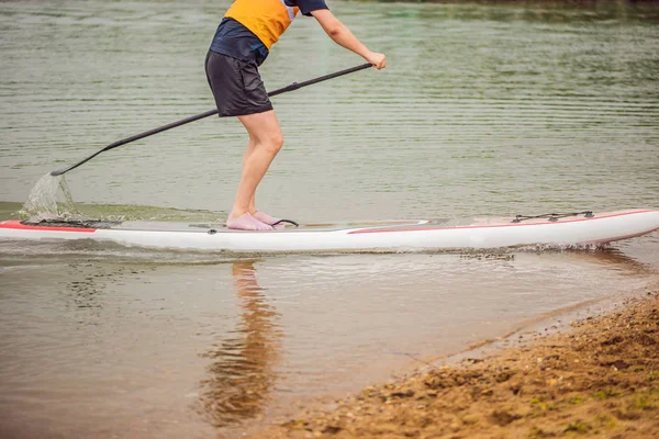 Men on a SUP board in the river or in the sea — Stock Photo, Image