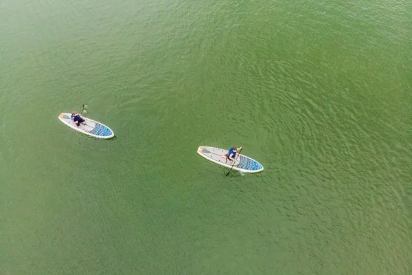 希腊水上运动比赛时 男子漂浮在海湾的冲浪板上的鸟图 — 图库照片