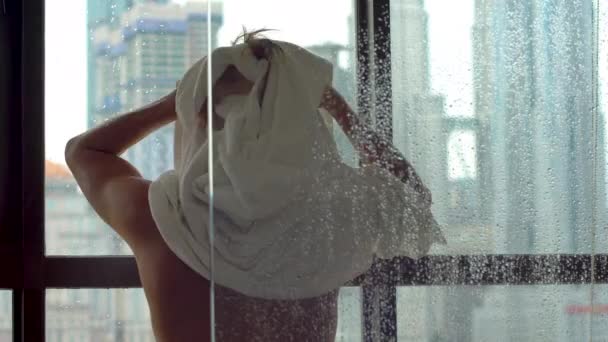 Man in the bathroom wipes his head with a towel after a shower — Stock Video