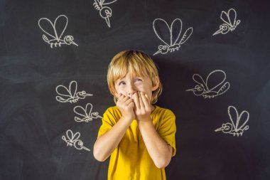Komik yüz ifadesi ve gözümün önünde blackboard ile çizilmiş tebeşir sivrisinek sokması ile küçük çocuk. 