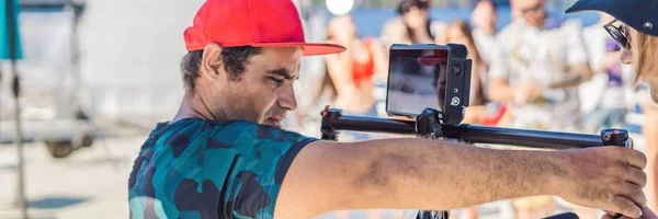 Professional steadicam operator uses a 3-axis camera stabilizer system on a commercial production set BANNER, LONG FORMAT — Stock Photo, Image