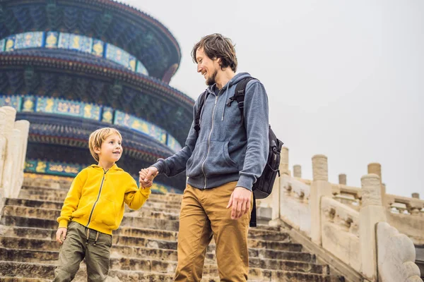 Father and son walking on steps in Temple of Heaven in Beijing, China