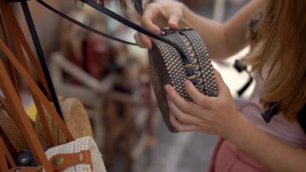 Foto em câmera lenta de uma jovem viajante visitando um mercado asiático escolhendo a lembrança — Vídeo de Stock
