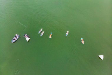Bay su sporu rekabet Yunanistan ise sup kurullarında yüzen insan havadan görünümü.