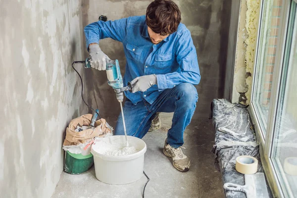 Jovem Pintor Masculino Amassar Massa Vidraceiro Balde Usando Misturador Mão — Fotografia de Stock