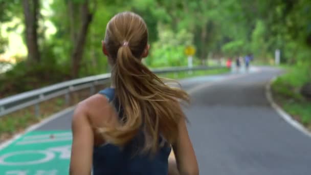 Steadicam toma de una joven corriendo en un parque tropical — Vídeo de stock