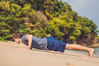 Kumsalda, sportif adam egzersizleri yapıyor çalışma dışarı genç erkek