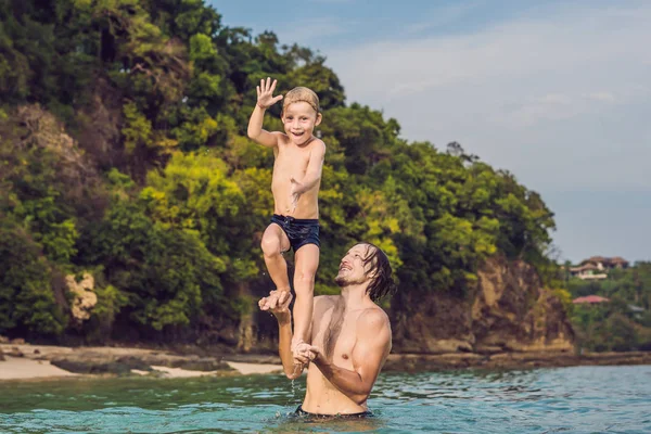 Padre e figlio che giocano sulla spiaggia durante il giorno — Foto Stock