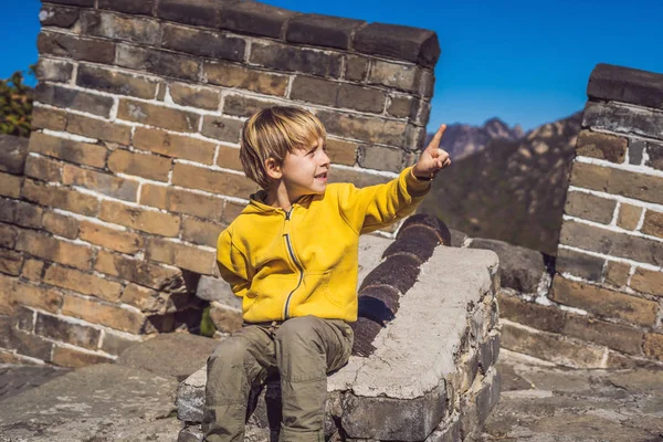 Happy cheerful joyful boy tourist at Great Wall of China having fun on travel smiling laughing and dancing during vacation trip in Asia. Chinese destination. Travel with children in China concept — Stock Photo, Image