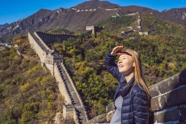 Happy cheerful joyful tourist woman at Great Wall of China having fun on travel smiling laughing and dancing during vacation trip in Asia. Girl visiting and sightseeing Chinese destination — Stock Photo, Image