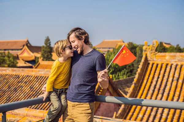 Enjoying vacation in China. Happy family with national chinese flag in Forbidden City. Travel to China with kids concept. Visa free transit 72 hours, 144 hours in China