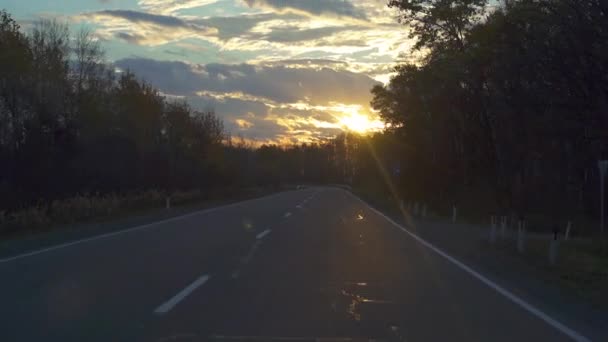 Slowmotion shot of a sunrise filmed from a traveling car. Travel by car concept — Stock Video