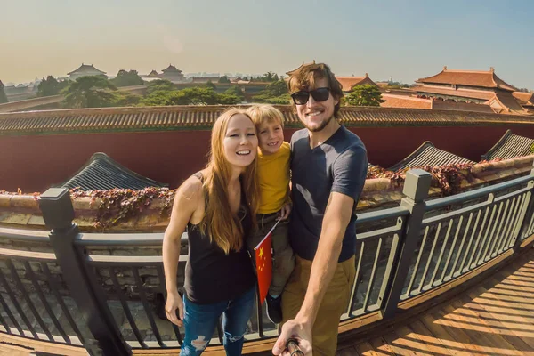 Enjoying vacation in China. Happy family with national chinese flag in Forbidden City. Travel to China with kids concept. Visa free transit 72 hours, 144 hours in China