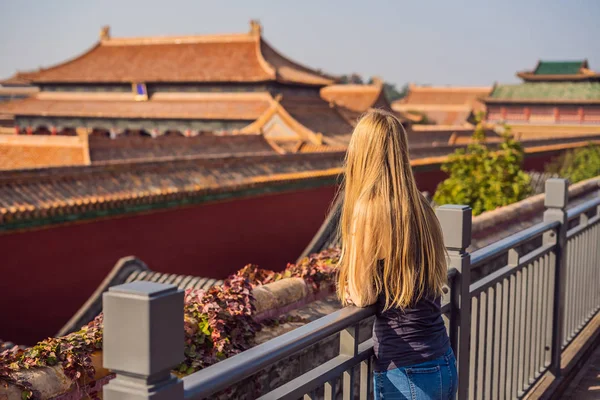 Enjoying vacation in China. Young woman in Forbidden City. Travel to China concept. Visa free transit 72 hours, 144 hours in China