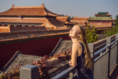 Enjoying vacation in China. Young woman in Forbidden City. Travel to China concept. Visa free transit 72 hours, 144 hours in China clipart