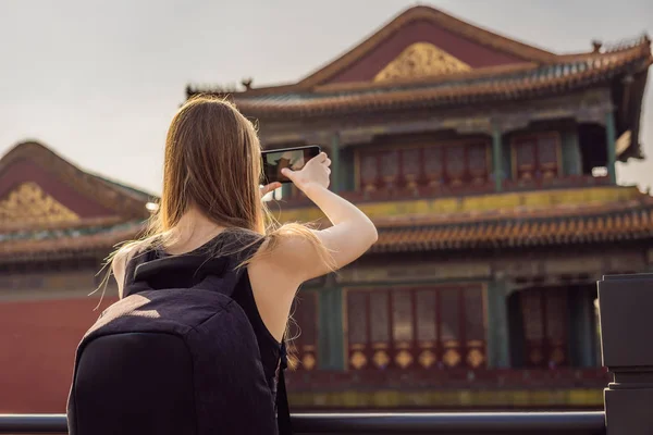 Enjoying vacation in China. Young woman in Forbidden City. Travel to China concept. Visa free transit 72 hours, 144 hours in China