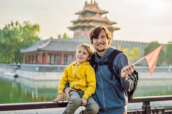 Enjoying vacation in China. Happy family with national chinese flag in Forbidden City. Travel to China with kids concept. Visa free transit 72 hours, 144 hours in China